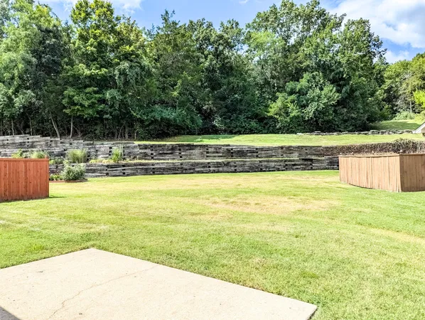 a view of a swimming pool with an outdoor seating and a forest