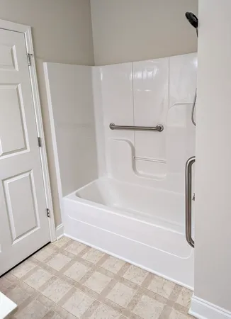a bathroom with a shower and a bath tub