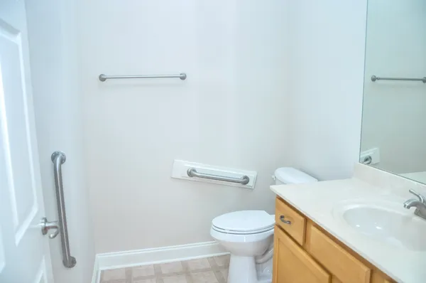 a white toilet sitting next to a bathroom sink