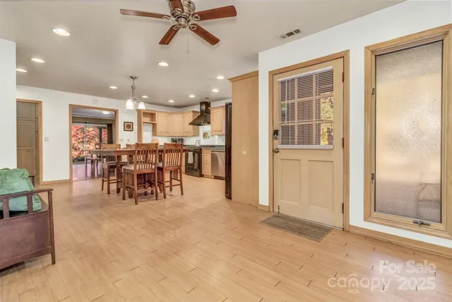 a large kitchen with a table and chairs
