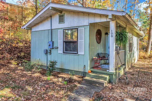 a backyard of a house with table and chairs