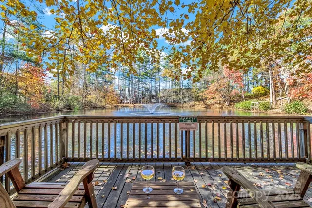 a kitchen with stainless steel appliances kitchen island granite countertop a table chairs sink and cabinets
