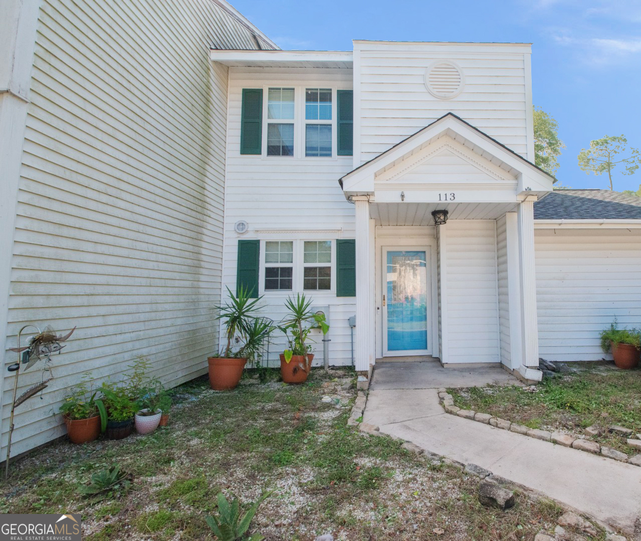 113 Inlet Reach Circle St. Marys, GA 31558 - Photo 1 of 18 a front view of a house with a yard