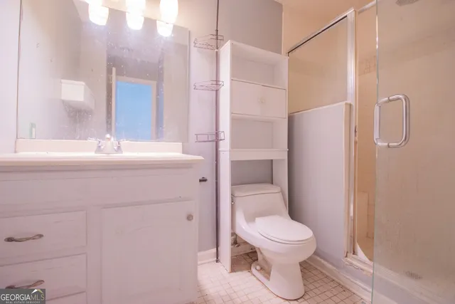 a bathroom with a toilet sink and a mirror