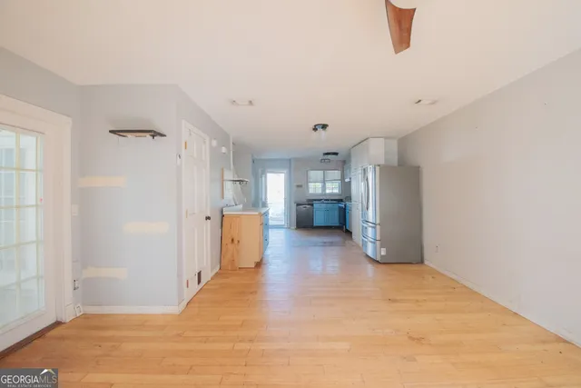 a view of empty room with wooden floor