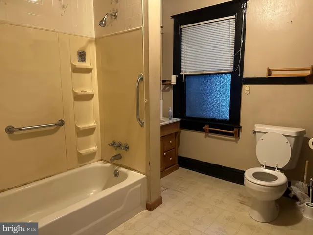 a bathroom with a toilet and a bathtub