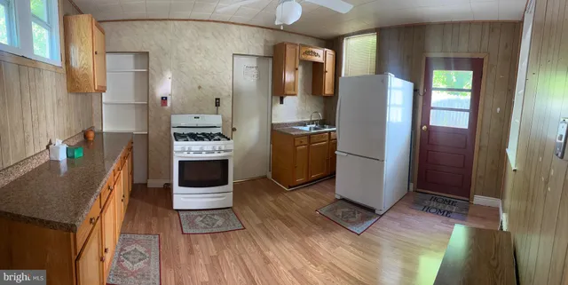 a kitchen with stainless steel appliances granite countertop a refrigerator and a stove