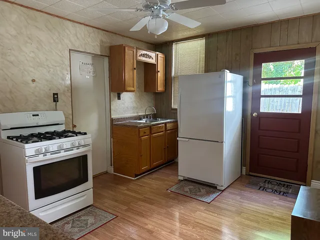a kitchen with a stove and a refrigerator
