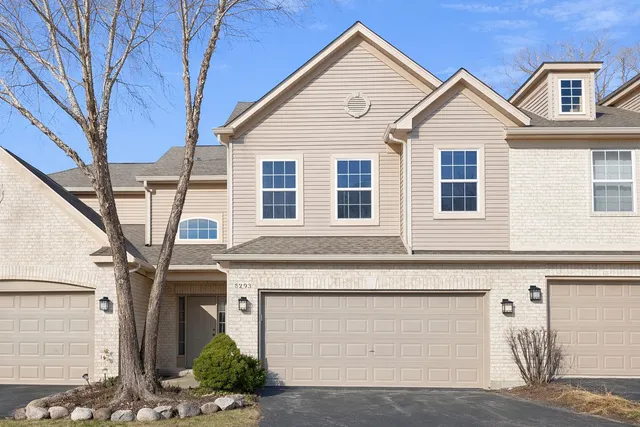 an empty room with ceiling fan and windows