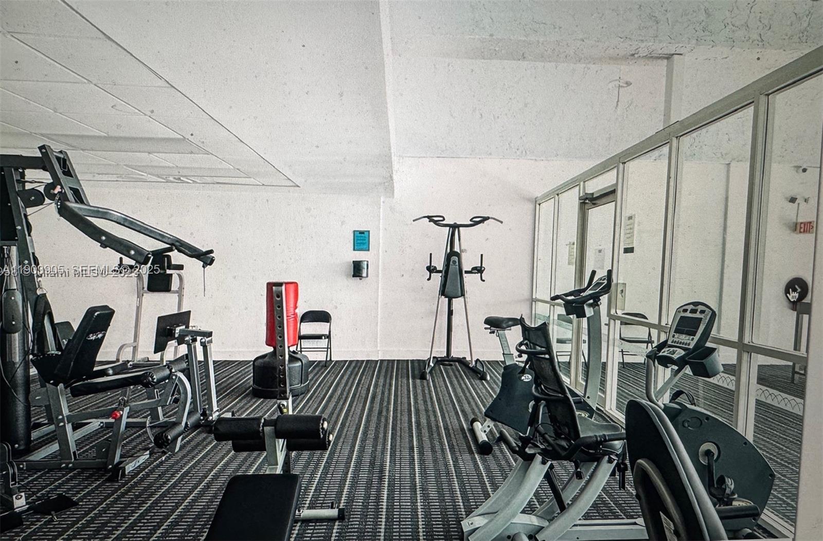 496 Northwest 165th Street, Unit D614 Miami, FL 33169 - Photo 2 of 10 a view of a room with gym equipment