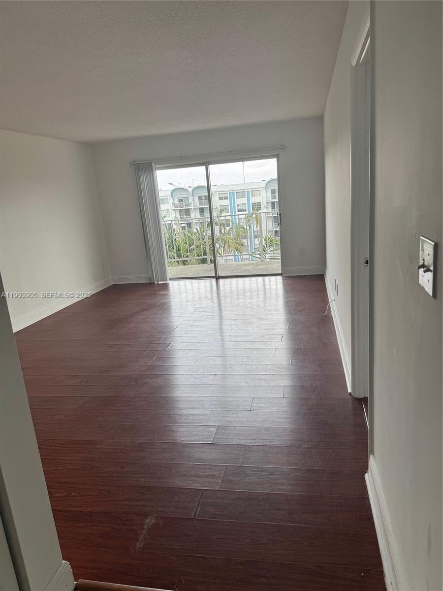 496 Northwest 165th Street, Unit D614 Miami, FL 33169 - Photo 3 of 10 a view of a room with wooden floor and window