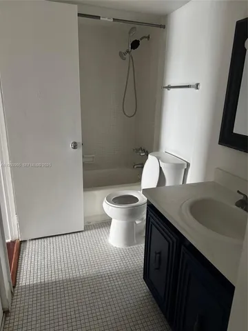 a bathroom with a granite countertop sink a toilet and a mirror