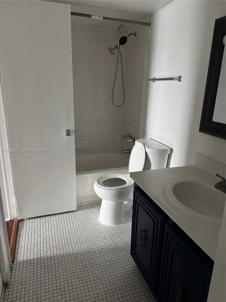 496 Northwest 165th Street, Unit D614 Miami, FL 33169 - Photo 4 of 10 a bathroom with a granite countertop sink a toilet and a mirror