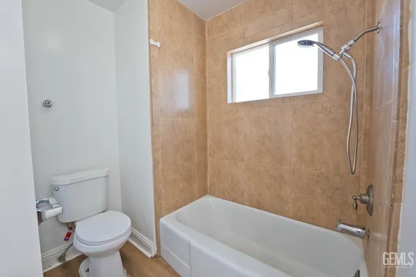 a bathroom with a toilet and a bathtub