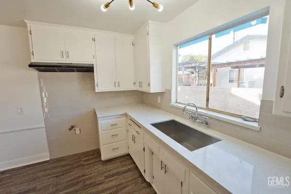 a kitchen with a sink window and cabinets