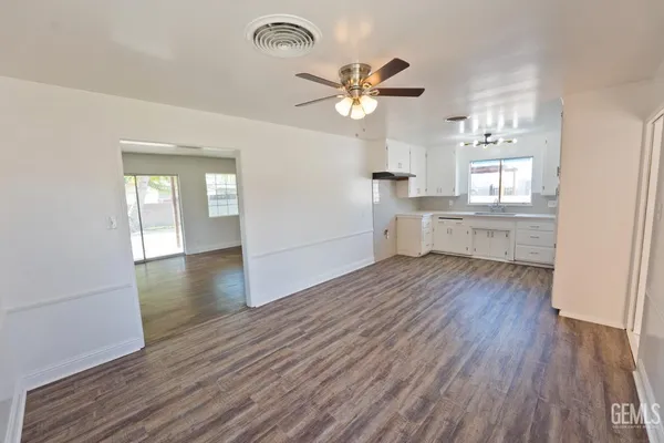 a view of a kitchen with wooden floor a sink and a window