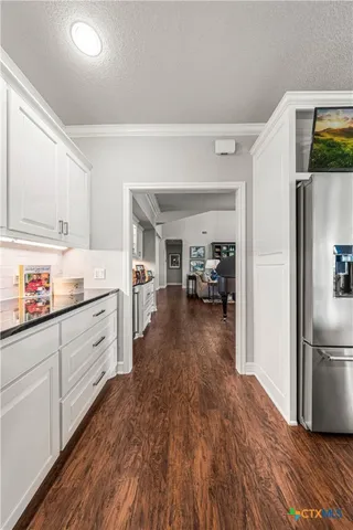 a bathroom with a double vanity sink a mirror and a bathtub