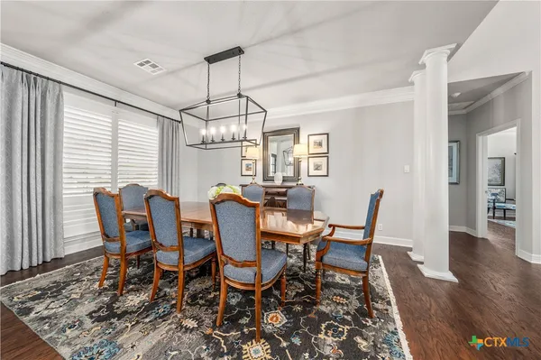 a bathroom with a granite countertop toilet sink and mirror