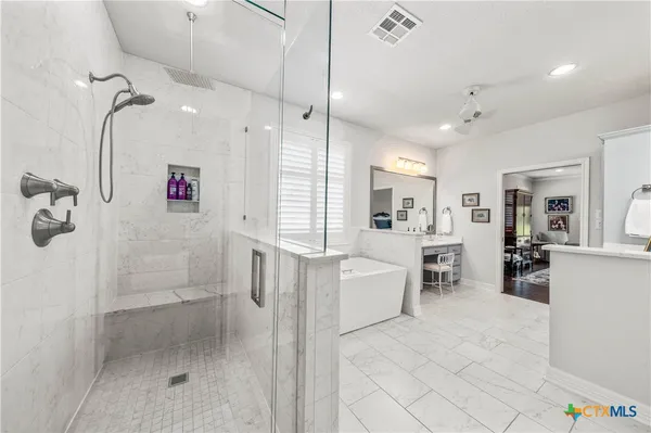 a living room with furniture stairs and a window