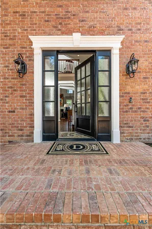 a living room with furniture a rug and a fireplace