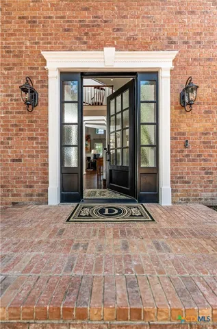 a living room with furniture a rug and a fireplace