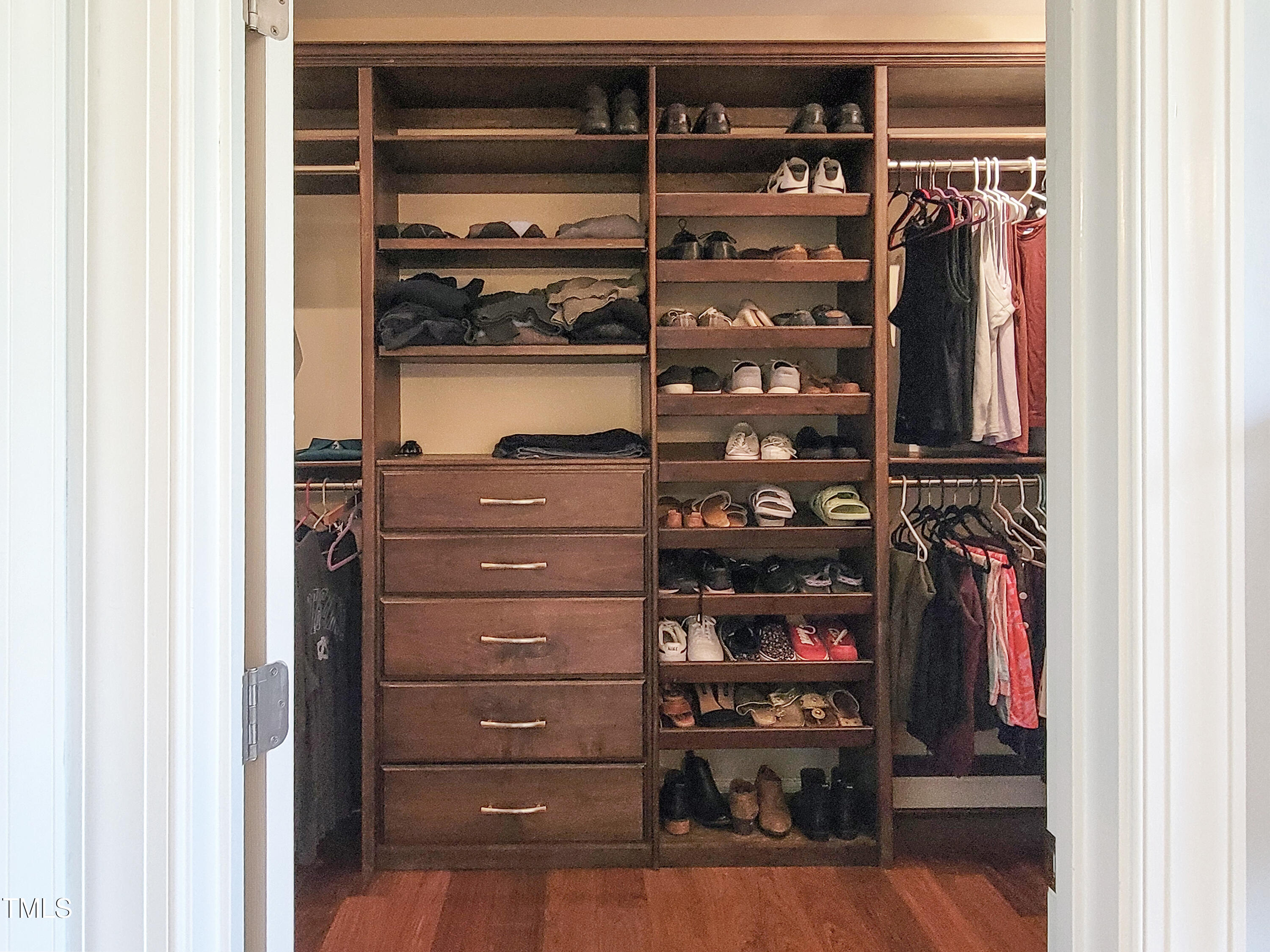 7502 Hedfield Way Durham, NC 27713 - Photo 22 of 28 a view of walk in closet with clothes and shoes