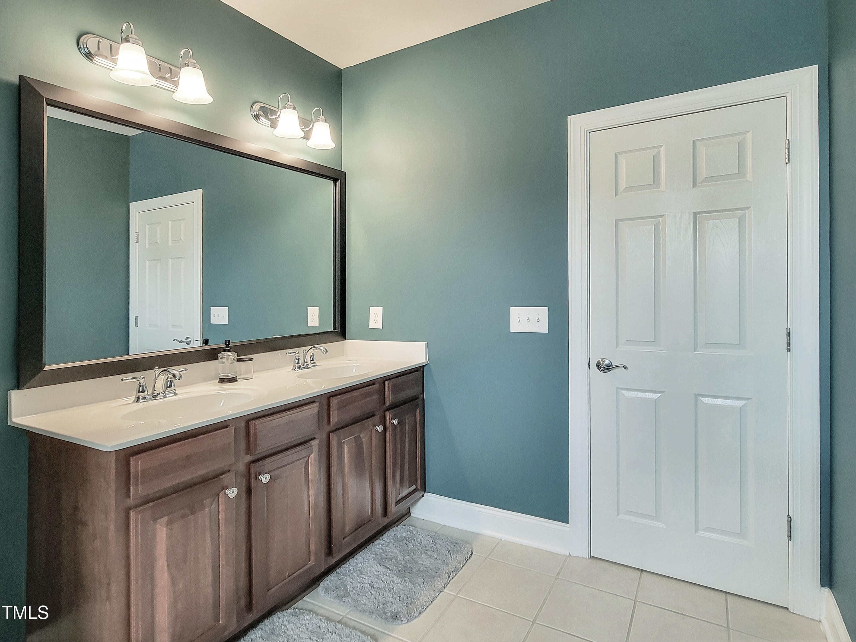 7502 Hedfield Way Durham, NC 27713 - Photo 23 of 28 a bathroom with a double vanity sink and a mirror