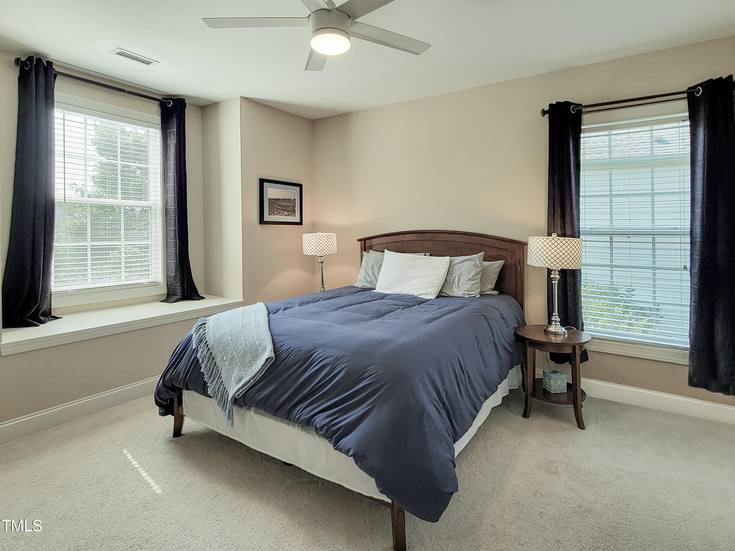 7502 Hedfield Way Durham, NC 27713 - Photo 24 of 28 a bedroom with a bed chair and a window