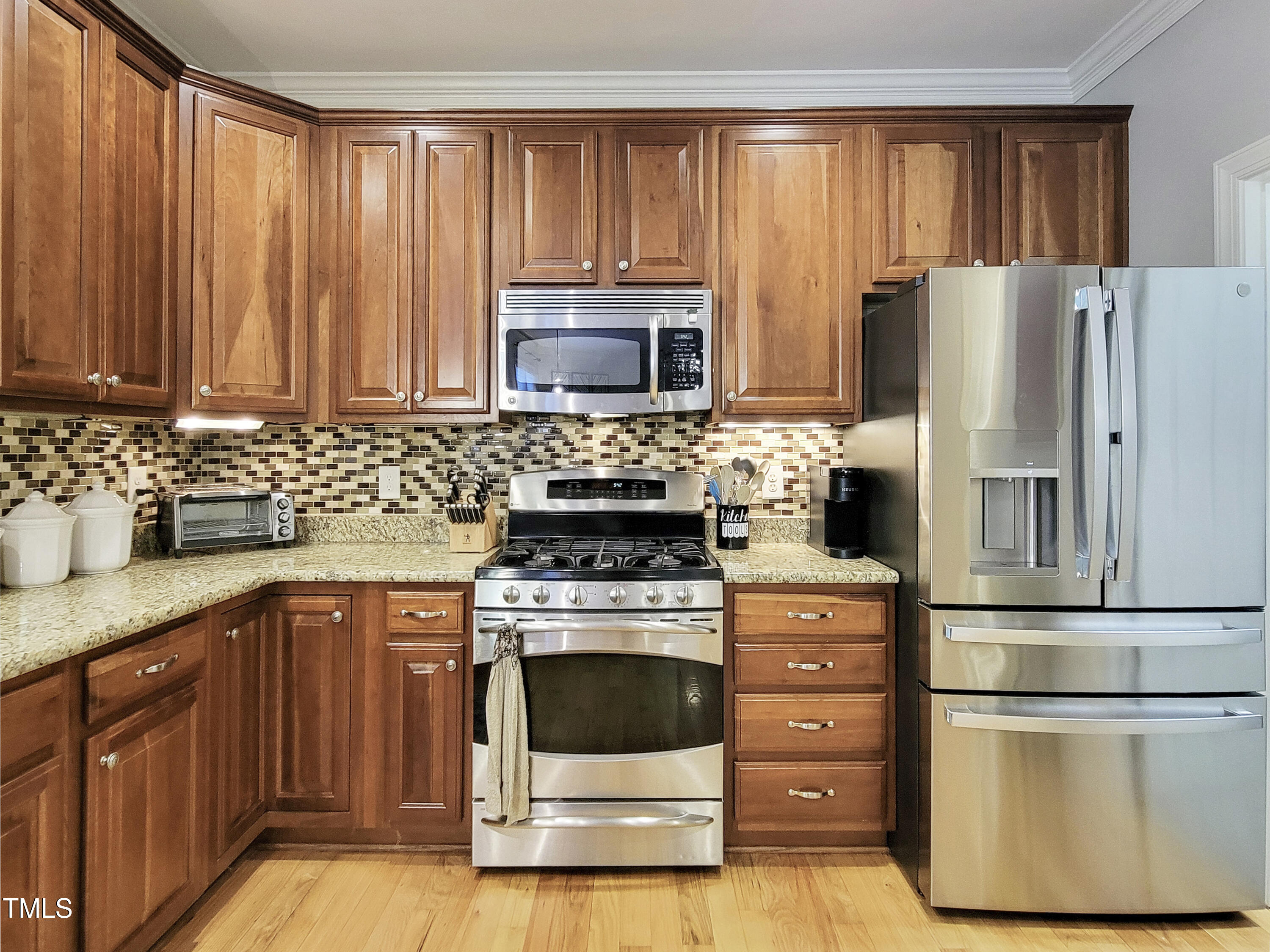 7502 Hedfield Way Durham, NC 27713 - Photo 4 of 28 a kitchen with cabinets appliances and a counter space