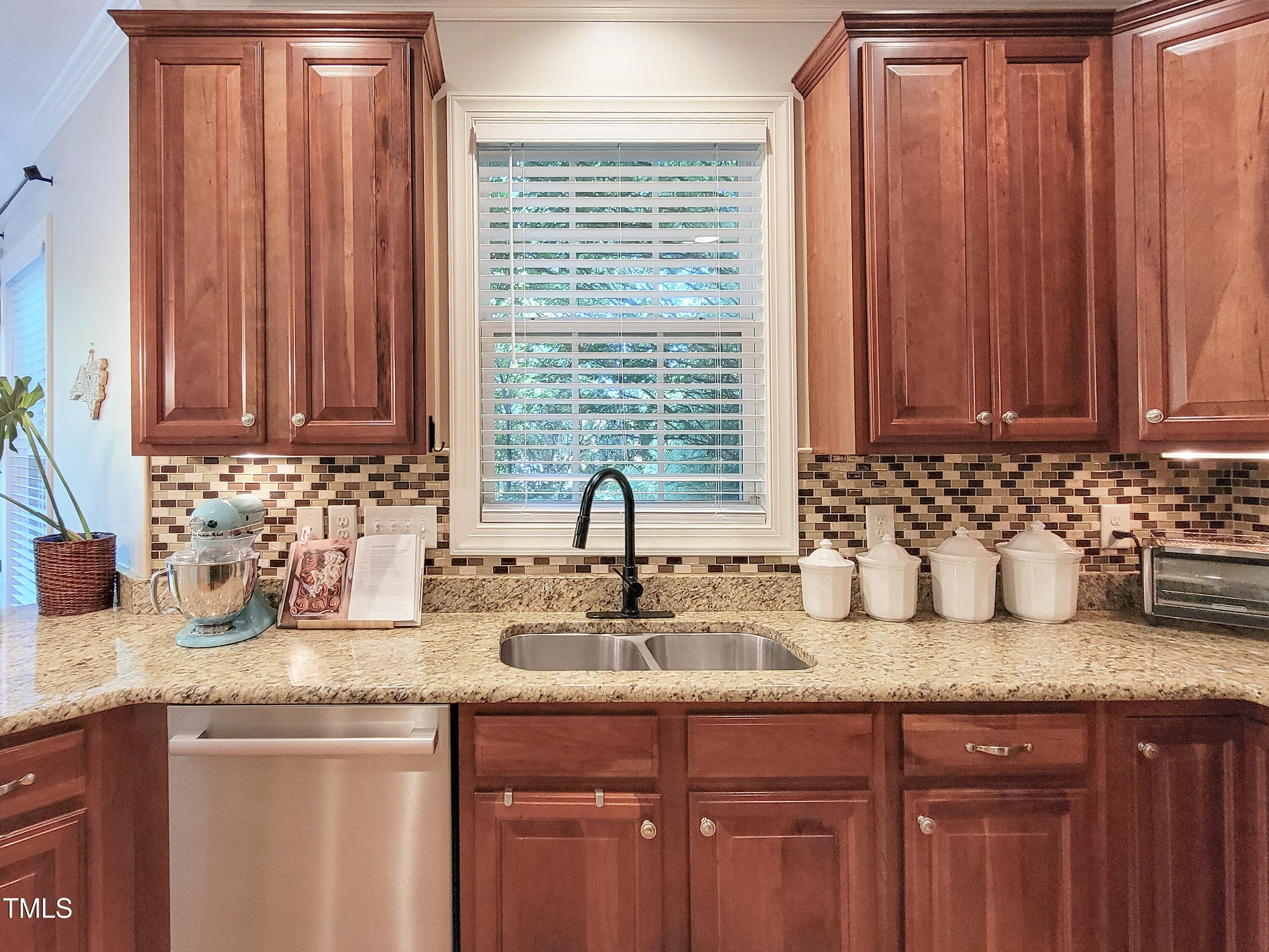 7502 Hedfield Way Durham, NC 27713 - Photo 6 of 28 a kitchen with granite countertop a sink a window and potted plant