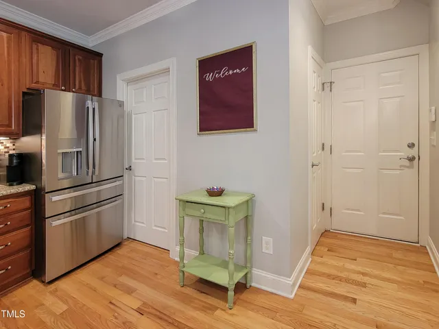 a kitchen with stainless steel appliances granite countertop a refrigerator and a stove