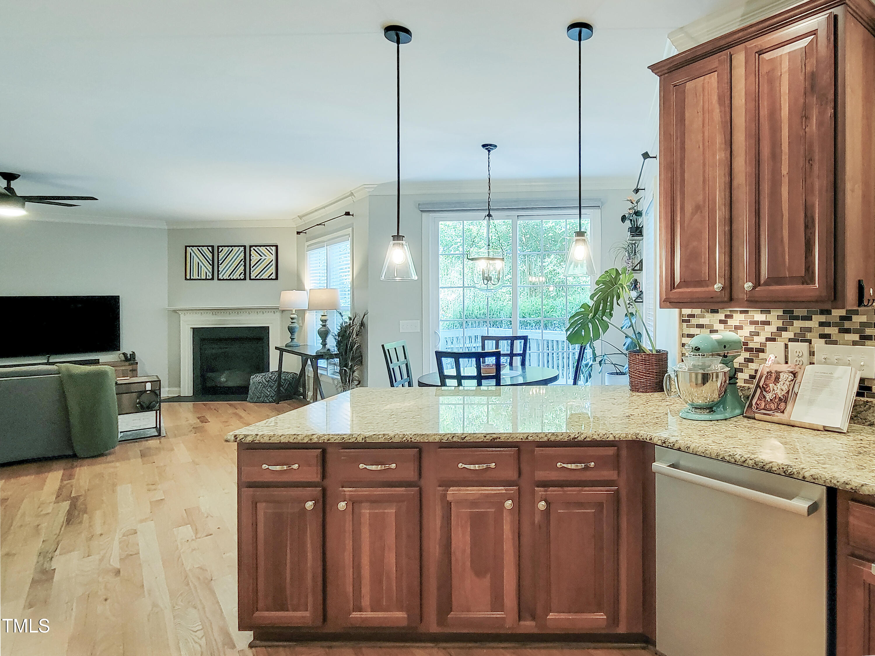 7502 Hedfield Way Durham, NC 27713 - Photo 8 of 28 a kitchen with sink cabinets and living room