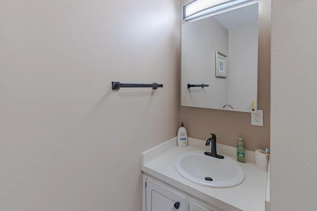 a bathroom with a sink and mirror