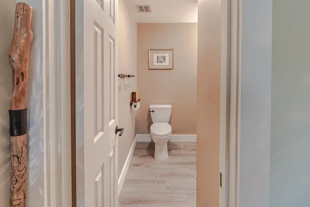 a white toilet sitting next to a bathroom sink