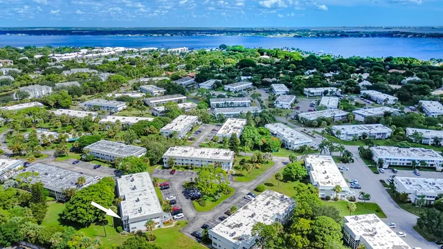 an aerial view of a houses with a yard