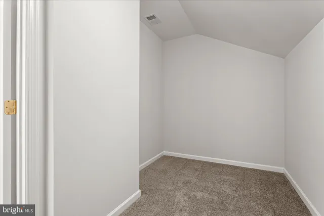 a view of an empty room with a sliding door