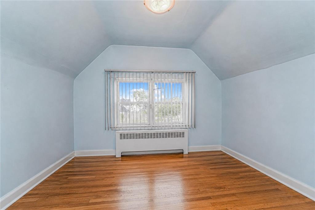 1352 Bay Ridge Parkway Brooklyn, NY 11228 - Photo 27 of 42 a view of an empty room with wooden floor and a window