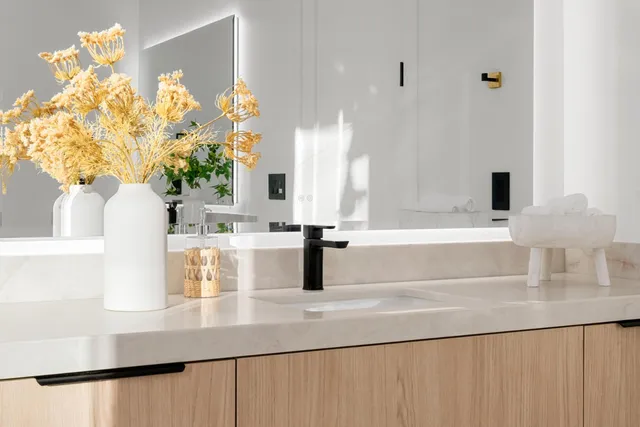 a living room with furniture a fireplace and a chandelier