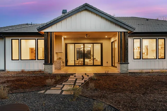 a view of a dining room with furniture and a potted plant