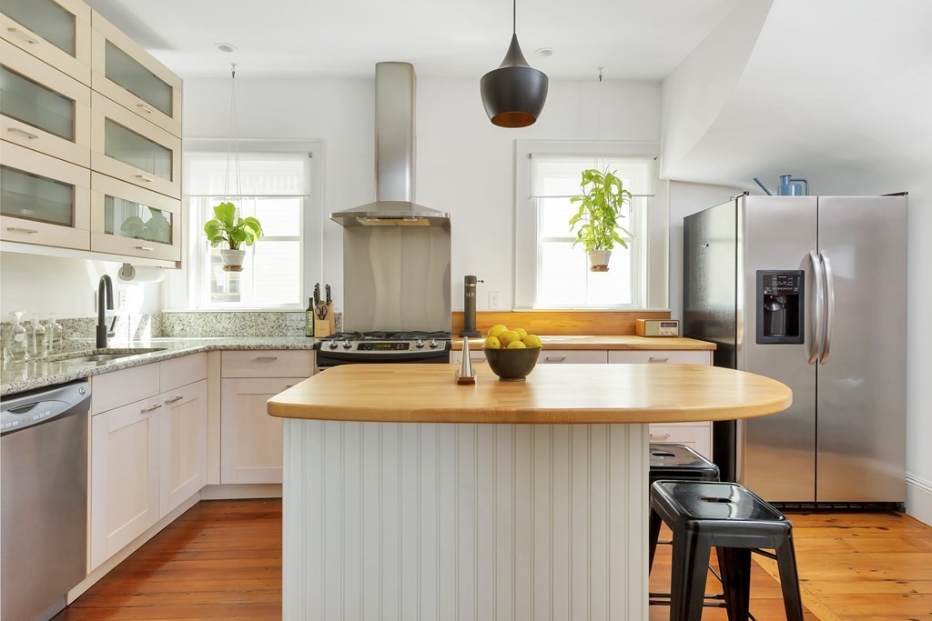 9 Joseph Street, Unit 1 Somerville, MA 02143 - Photo 5 of 17 a kitchen with stainless steel appliances a sink and a refrigerator