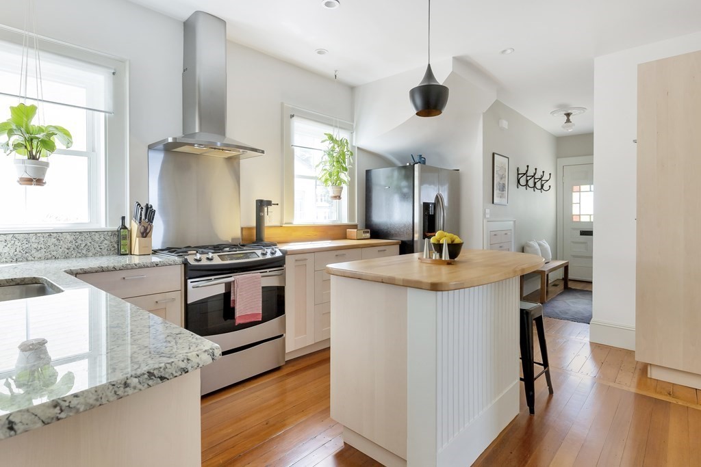 9 Joseph Street, Unit 1 Somerville, MA 02143 - Photo 6 of 17 a kitchen with stainless steel appliances granite countertop a sink a stove and a wooden floors