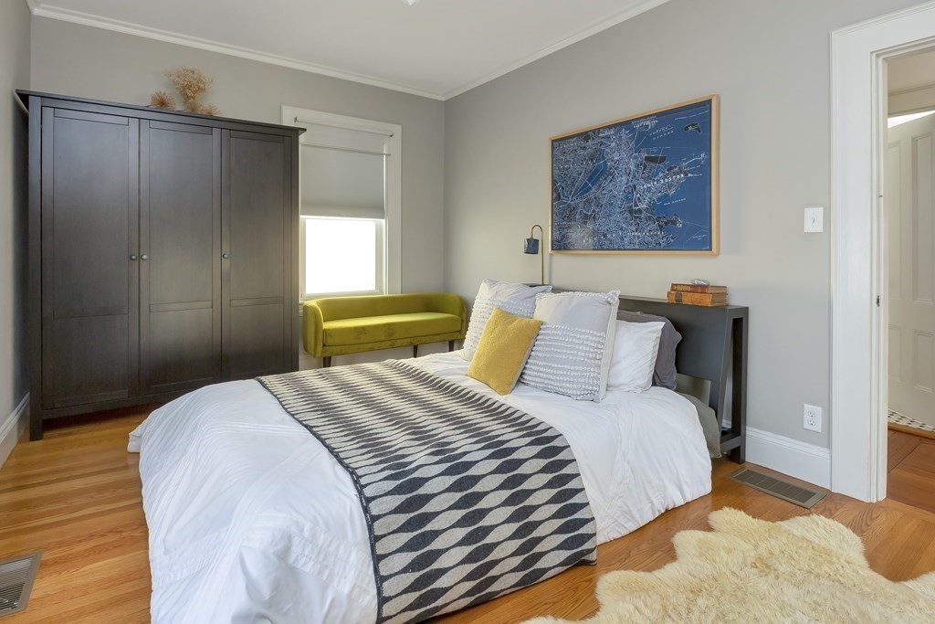 9 Joseph Street, Unit 1 Somerville, MA 02143 - Photo 7 of 17 a bedroom with a bed and a painting on the wall