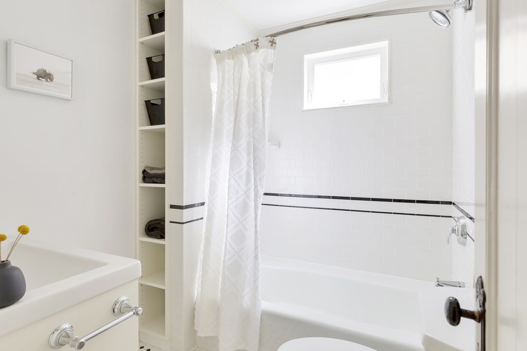 9 Joseph Street, Unit 1 Somerville, MA 02143 - Photo 9 of 17 a bathroom with a shower curtain and a sink