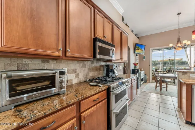 a view of an empty room with wooden floor and a ceiling fan