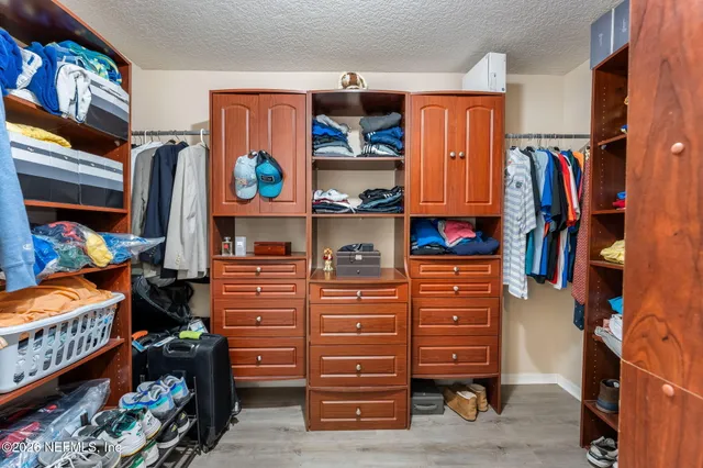 a view of a roof deck with couches and wooden floor