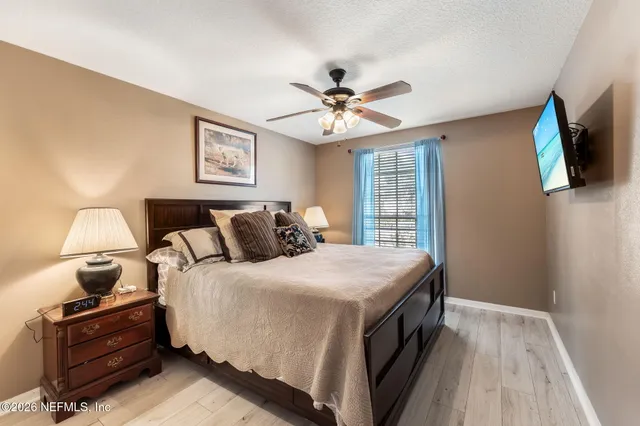 a view of a big house with a big yard and large trees