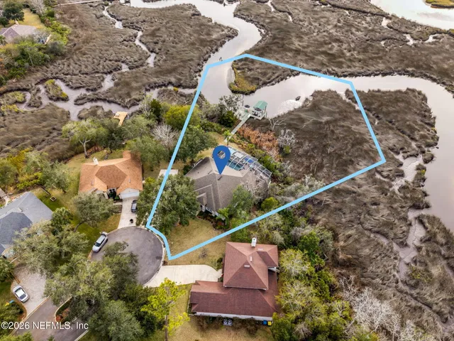 an aerial view of a house with a yard