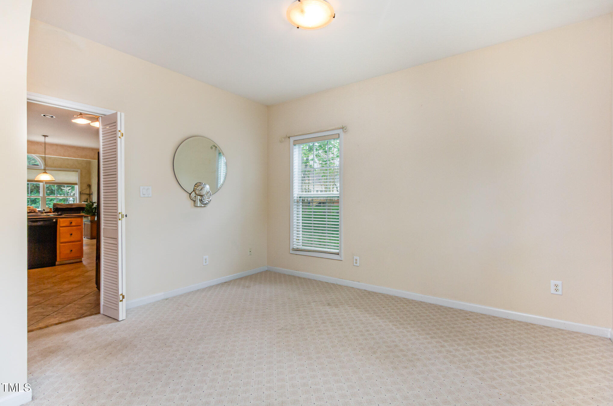 401 Stinhurst Drive Durham, NC 27713 - Photo 13 of 39 an empty room with windows and mirror
