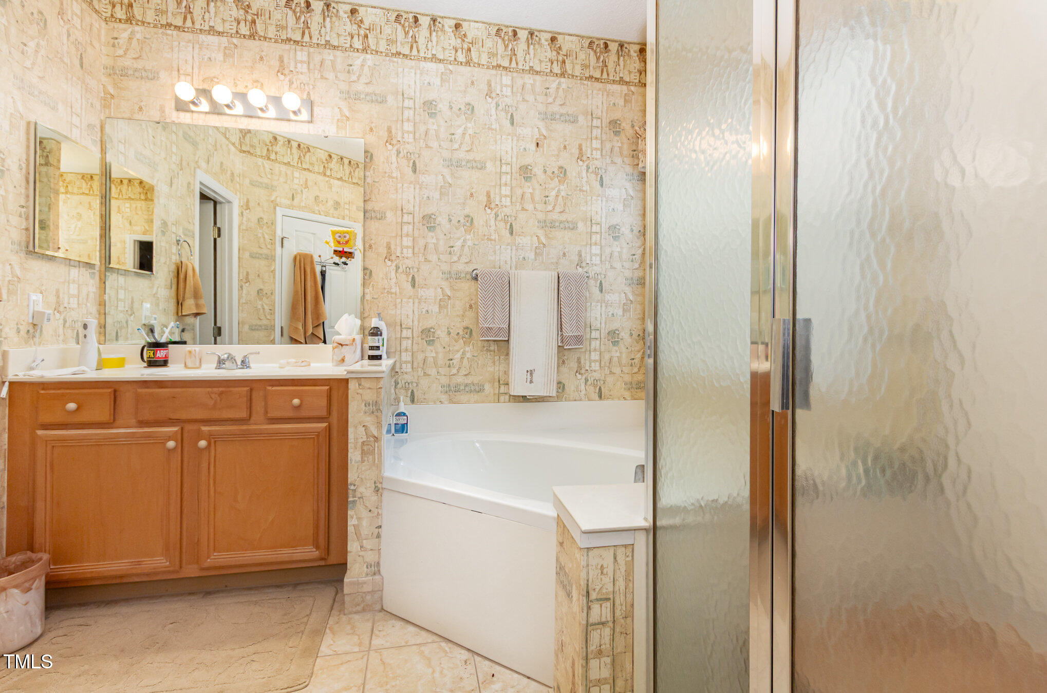401 Stinhurst Drive Durham, NC 27713 - Photo 20 of 39 a bathroom with a sink a mirror and a bathtub