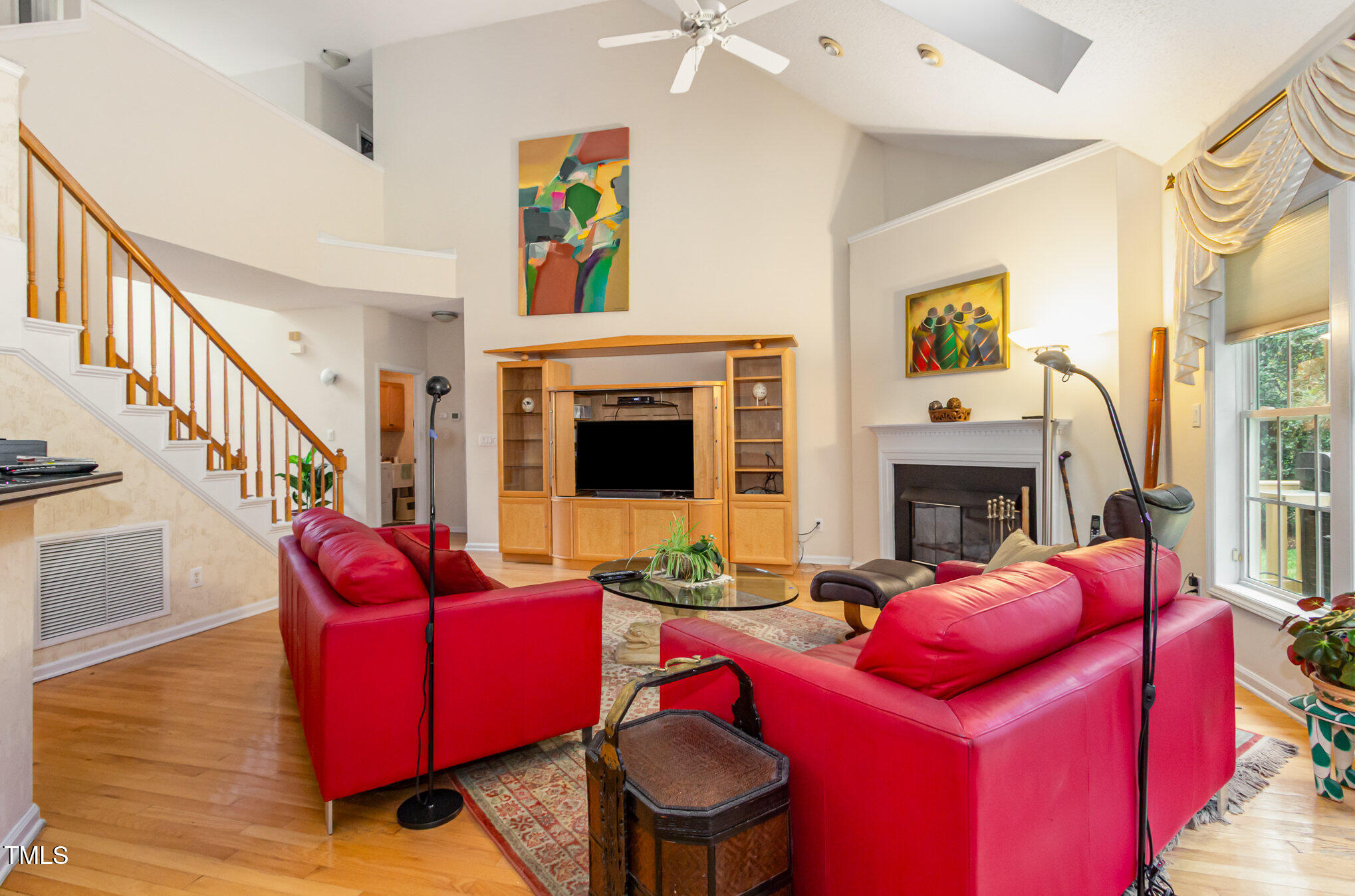 401 Stinhurst Drive Durham, NC 27713 - Photo 3 of 39 a living room with furniture a fireplace and a flat screen tv